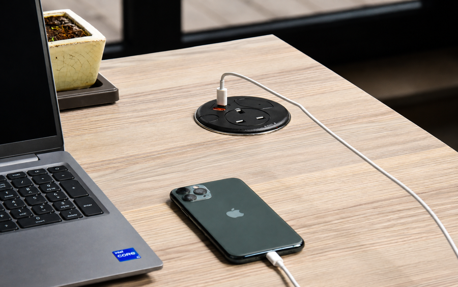 Punto in-desk power unit with USB charging installed in an office desk